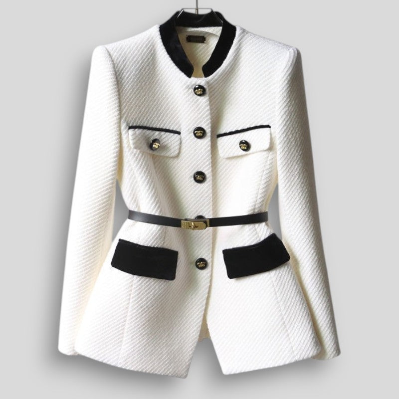 White blazer with black accents on a gray background