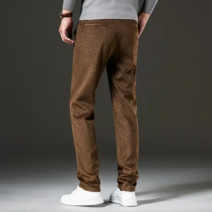 Brown patterned pants worn by a person on a dark background