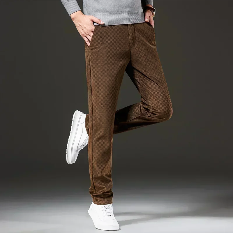 Brown checkered pants worn by a person on a dark background