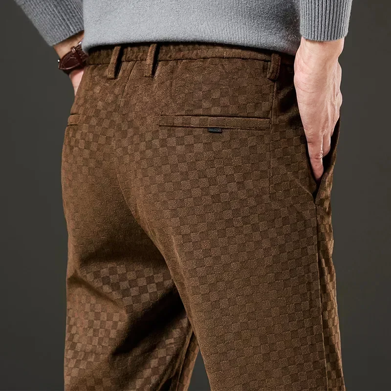 Brown checkered pants worn by a person on a dark background