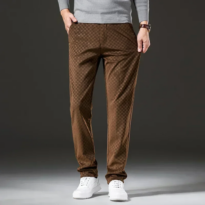 Brown patterned pants worn by a person on a dark background