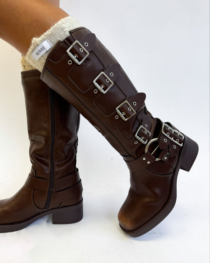 Brown knee-high boots with multiple buckles on a white background