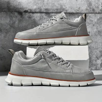 Gray sneakers with white soles on a gray background