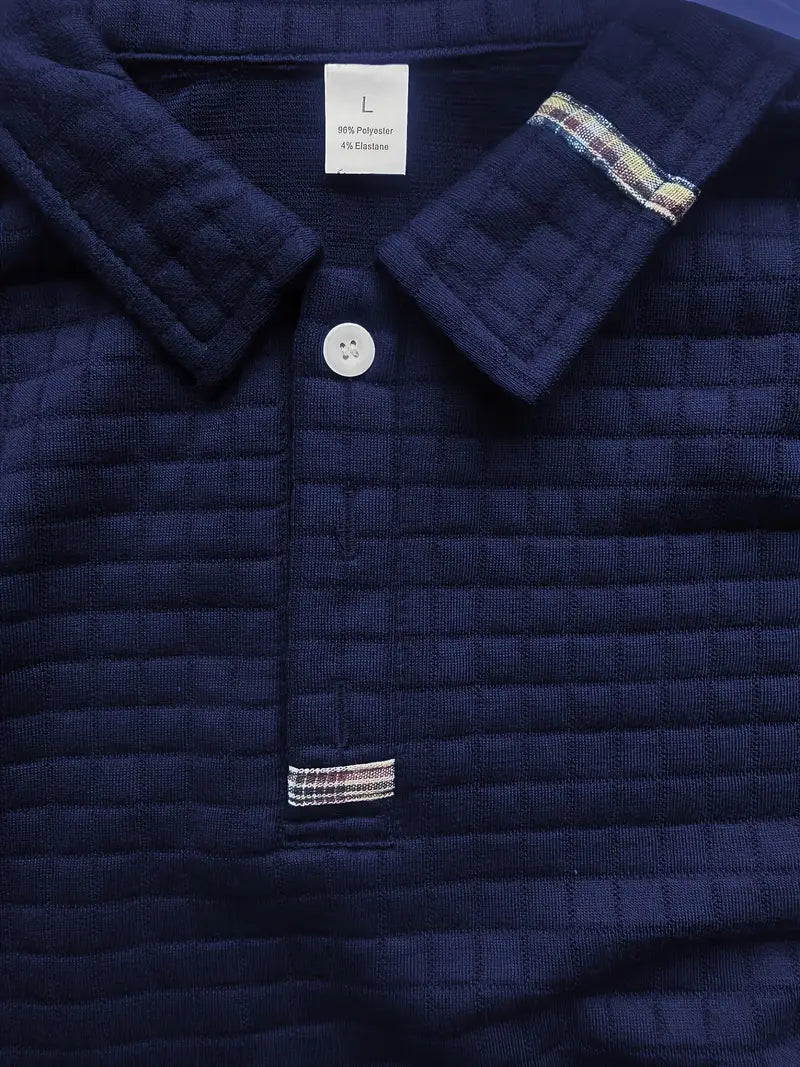 Navy quilted jacket with plaid trim and button detail, brand label visible.