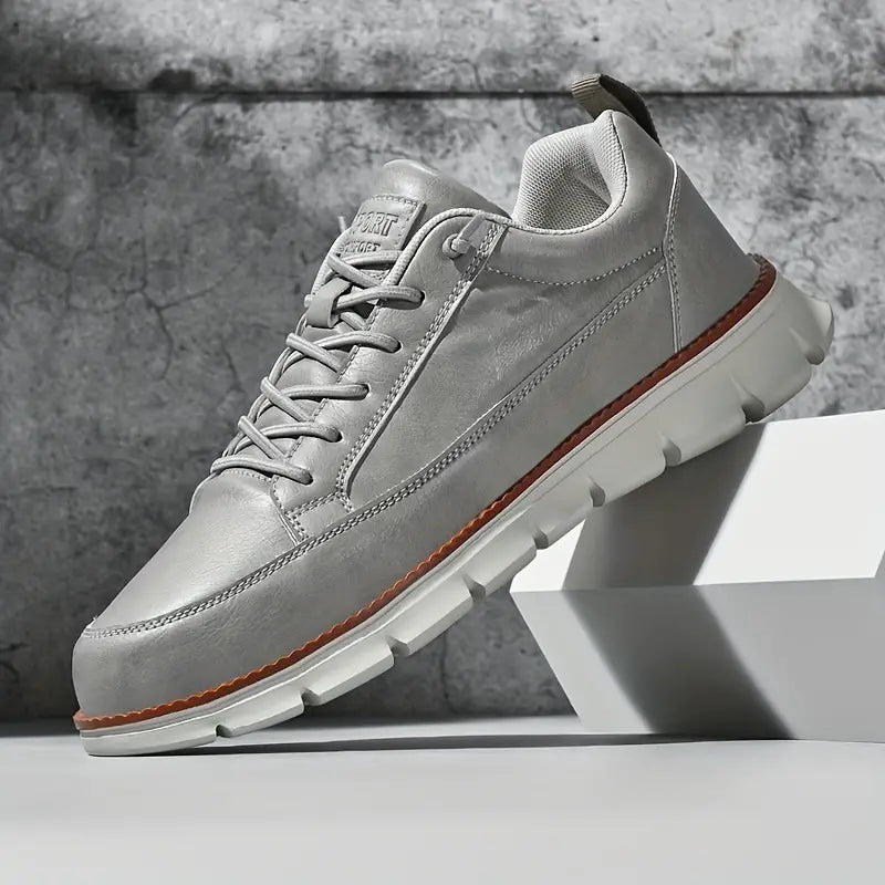 Gray sneaker with white sole on a gray background