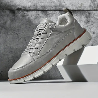 Gray sneaker with white sole on a gray background