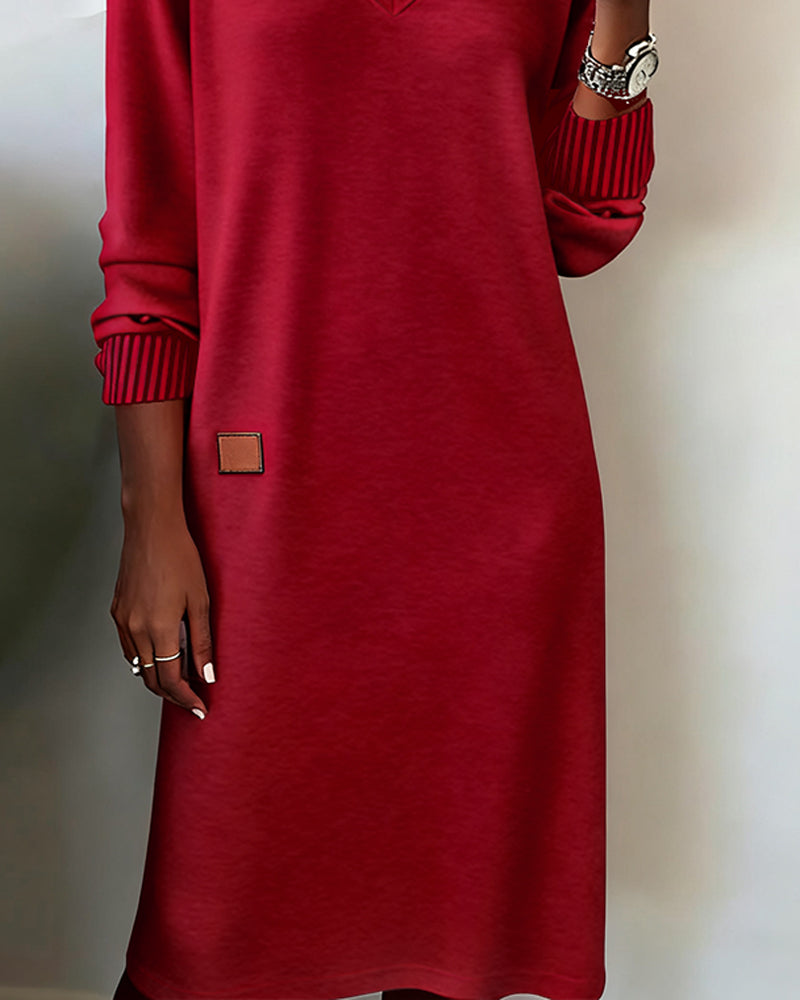 Red dress with a brown label on a neutral background