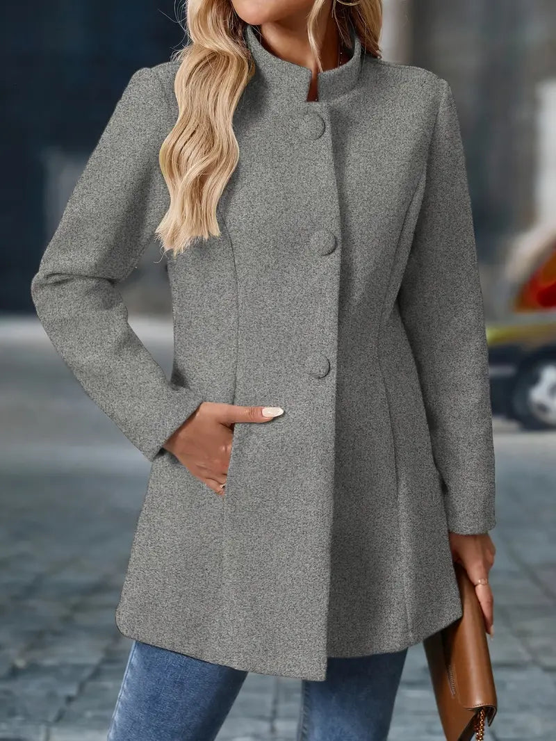 Woman wearing a gray coat with a blurred background