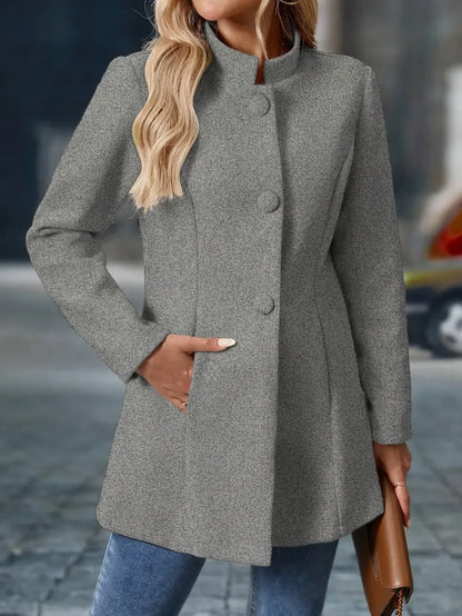 Woman wearing a gray coat with a blurred background