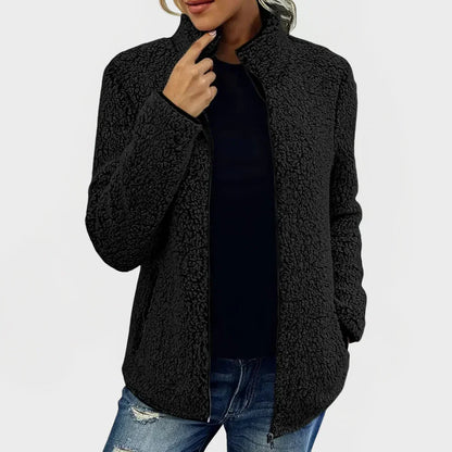 Person wearing a black sherpa jacket on a white background