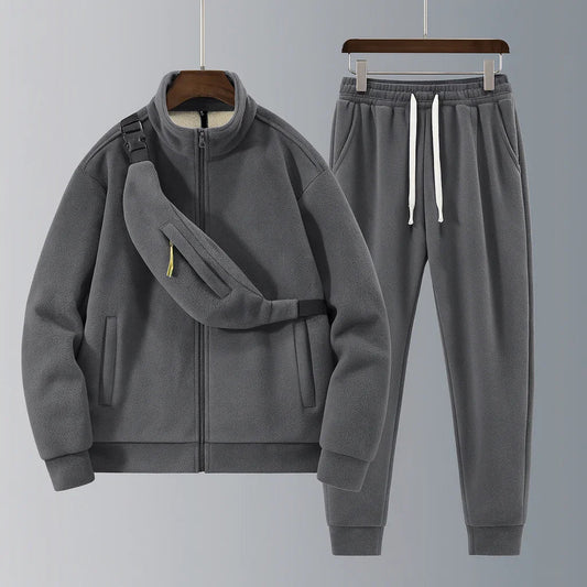 Gray tracksuit with jacket and pants on a gray background