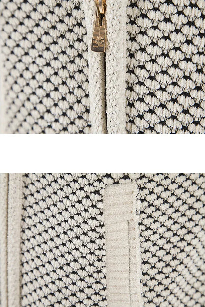 Close-up of a textured fabric with a zipper, featuring black and white patterns.