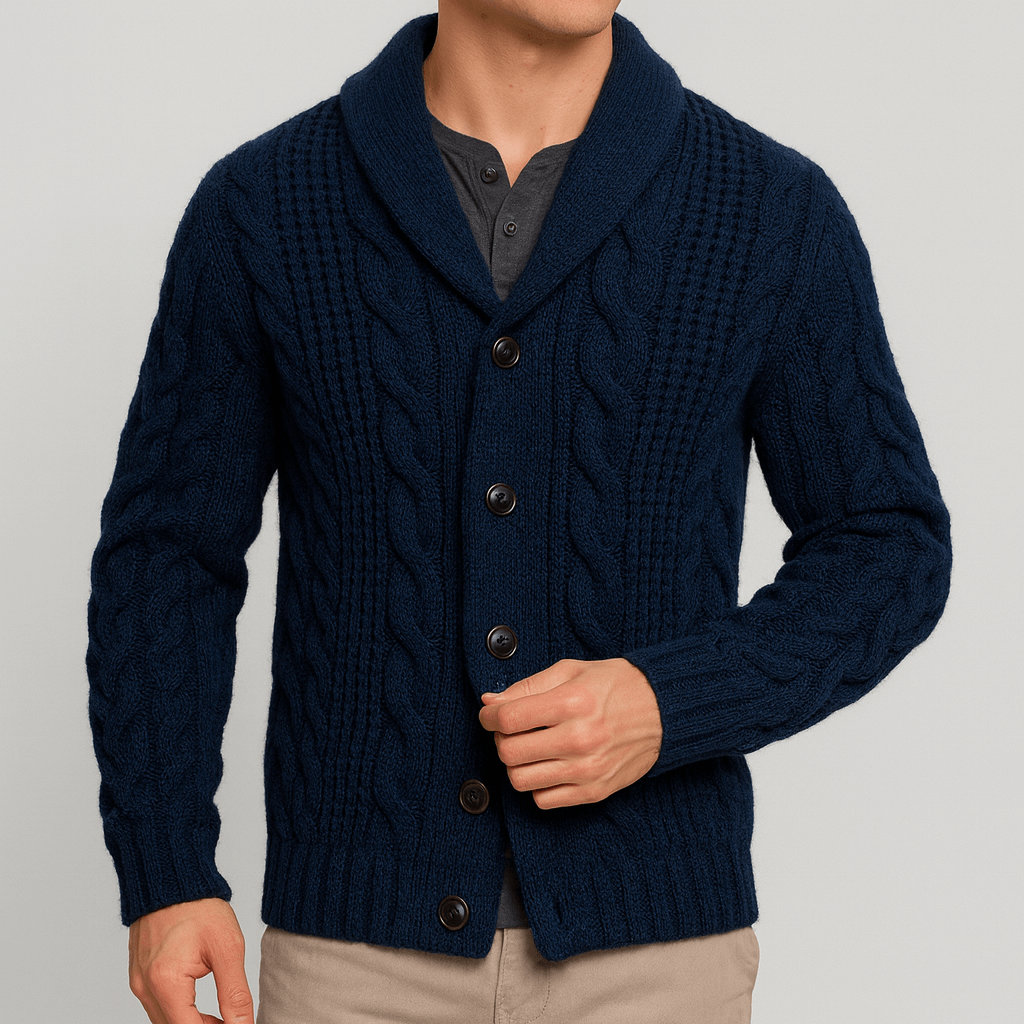 Navy blue cable knit cardigan worn by a person on a light gray background