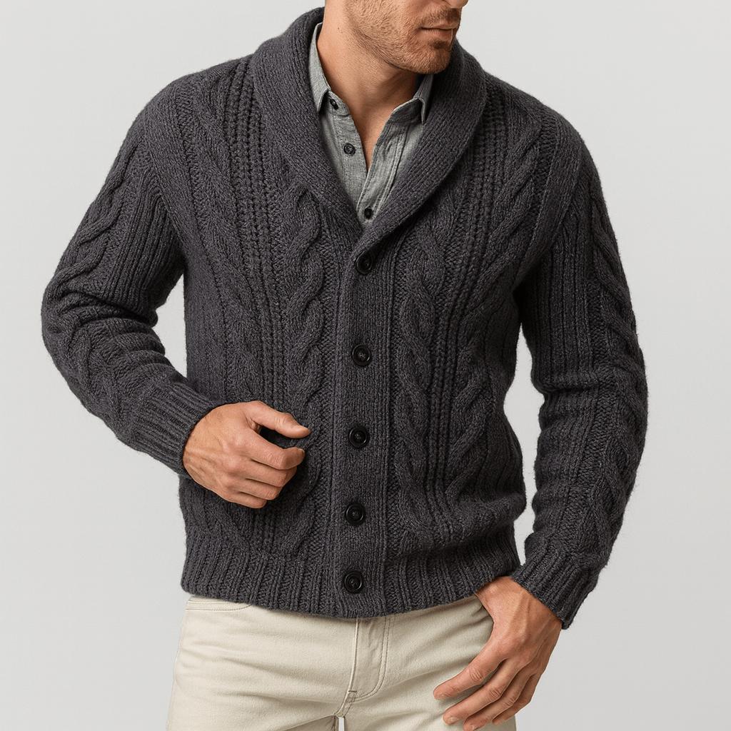 Man wearing a dark gray cable knit cardigan on a light gray background