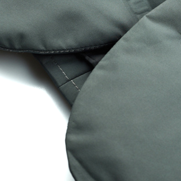 Close-up of a gray fabric surface with stitching details