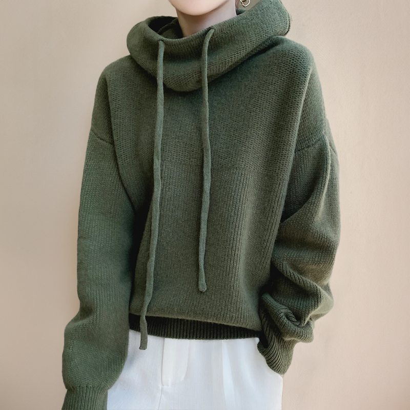 Person wearing a green turtleneck sweater
