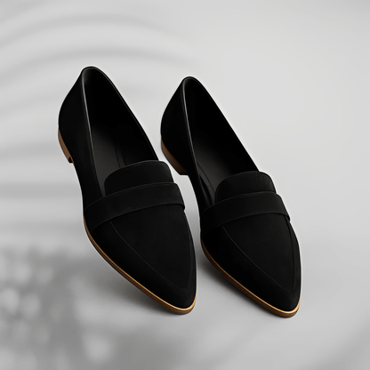 Pair of black loafers on a light gray background