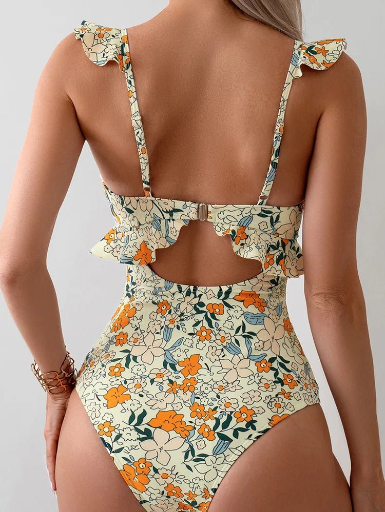 Floral patterned swimsuit with cut-out design on a neutral background