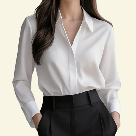 White blouse and black pants on a plain background
