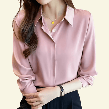 Pink satin shirt worn by a person on a light yellow background