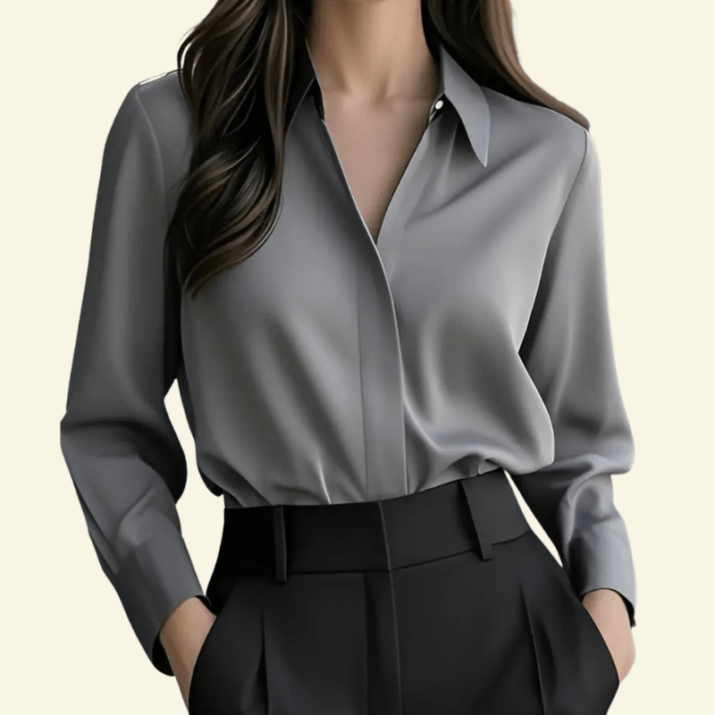 Gray blouse and black pants on a neutral background
