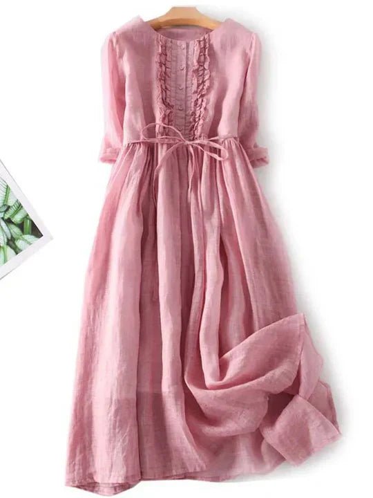 Pink dress on a hanger with a white background