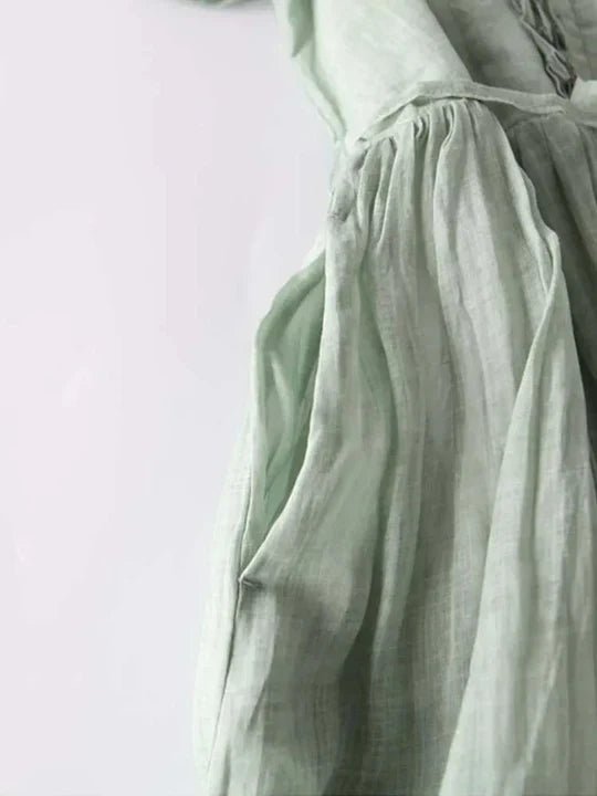 Light green fabric with a subtle pattern on a light gray background