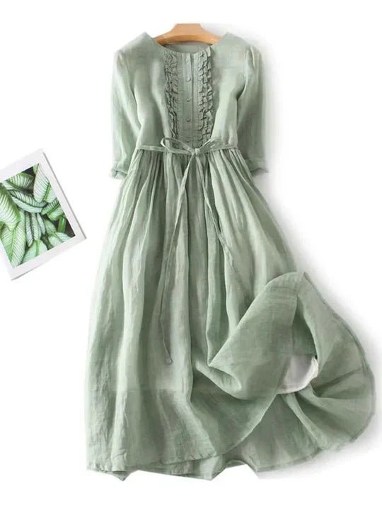 Green dress on a white background with a small inset of green leaves.