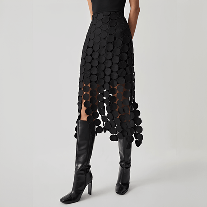 Black patterned skirt with sheer overlay worn by a model on a gray background