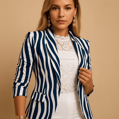 Woman wearing a blue and white striped blazer over a white lace top on a beige background