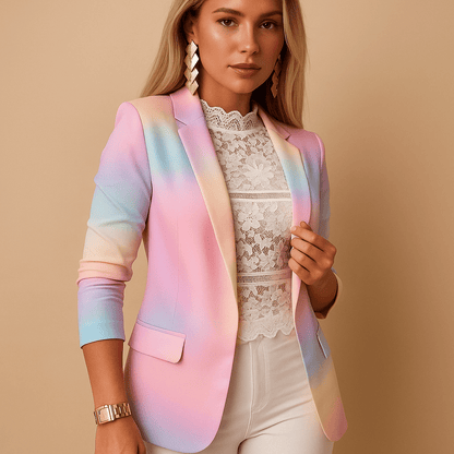 Woman wearing a pastel rainbow blazer over a white lace top on a beige background