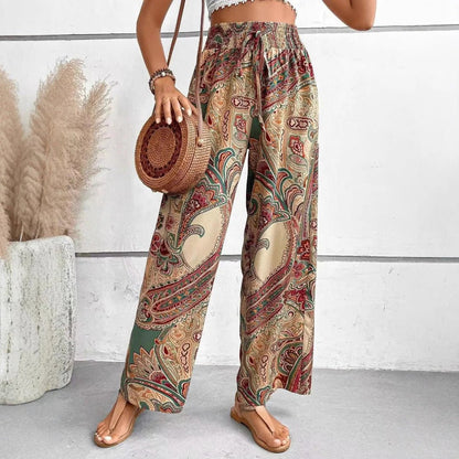 Person wearing patterned pants holding a round woven bag indoors.