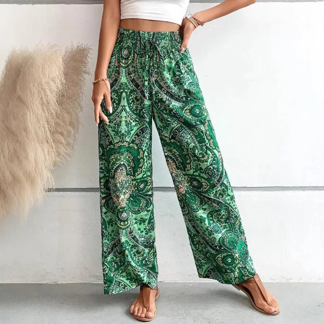 Green patterned pants worn by a person on a plain background