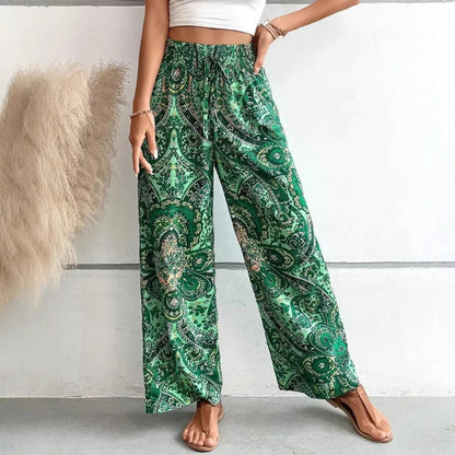 Green patterned pants worn by a person on a plain background