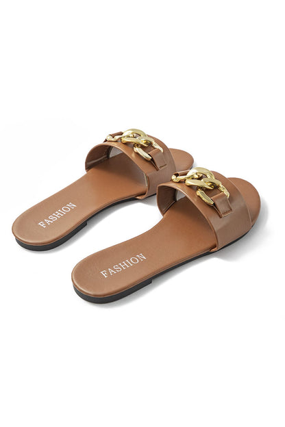 Brown sandals with gold chain detail on a white background