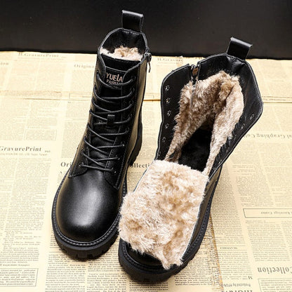 Black boots with fur lining on a newspaper background