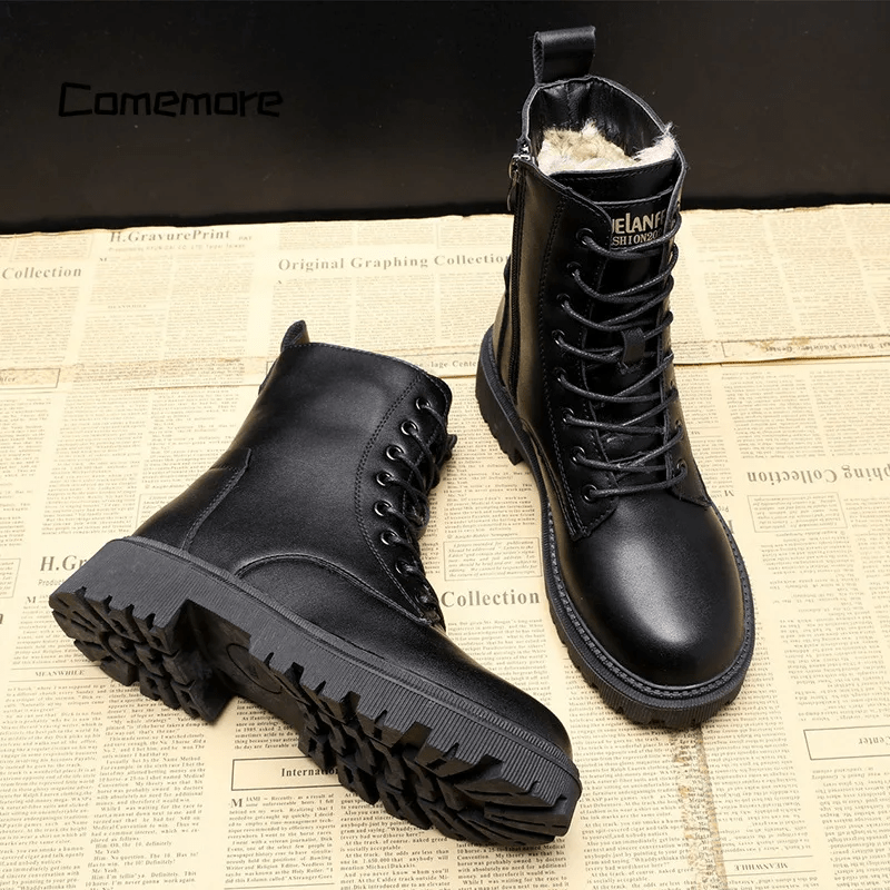 Black leather boots on a newspaper background with 'Camemore' branding.