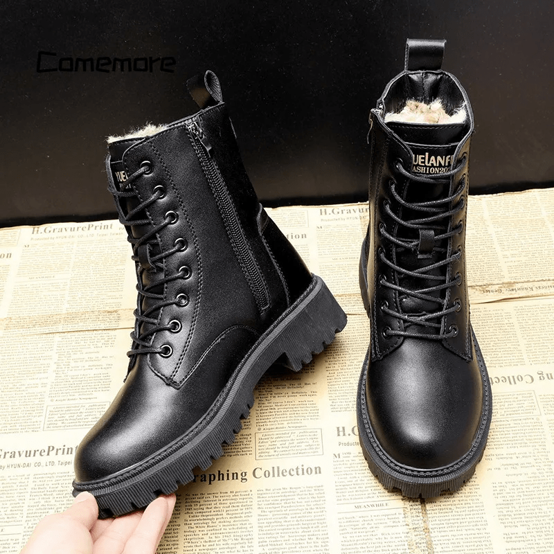 Black leather boots with fur lining on a newspaper background, brand 'Camemore' visible.