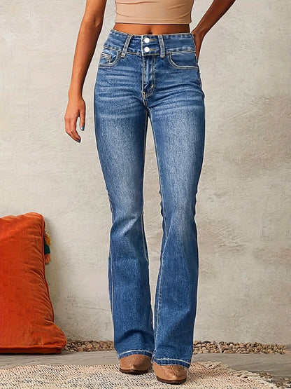 Person wearing blue jeans standing against a neutral background with an orange pillow.