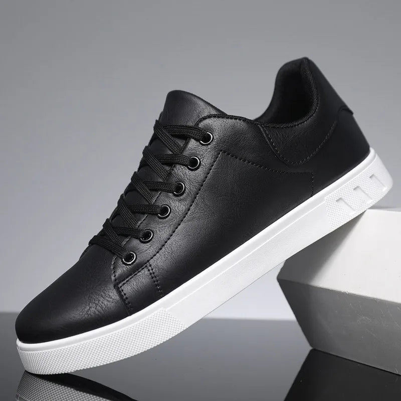 Black leather sneaker with white sole on a reflective surface
