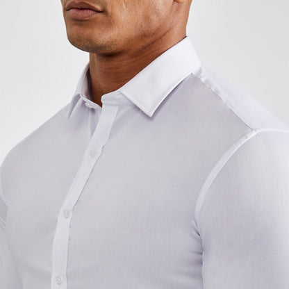 Close-up of a person wearing a light gray shirt with a white collar.
