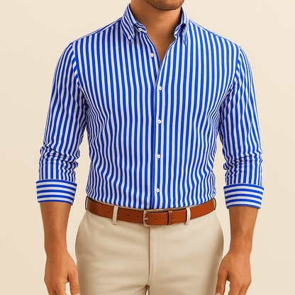 Man wearing a blue and white striped shirt with beige pants on a beige background