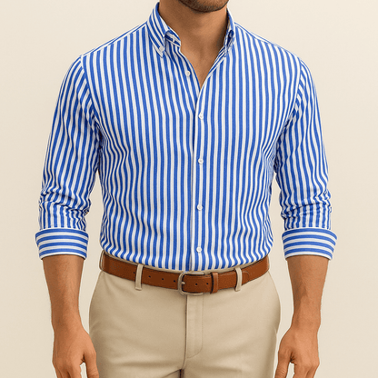 Man wearing a blue and white striped shirt with beige pants on a beige background
