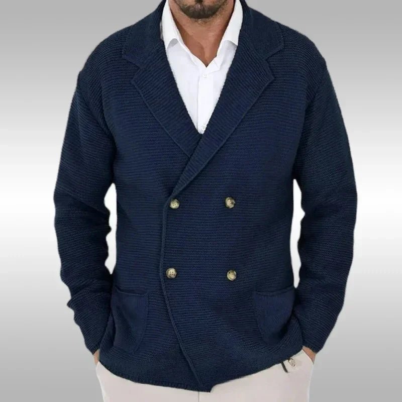 Navy blue double-breasted blazer worn by a person on a gray background