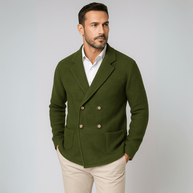 Man wearing a green blazer over a white shirt on a light gray background