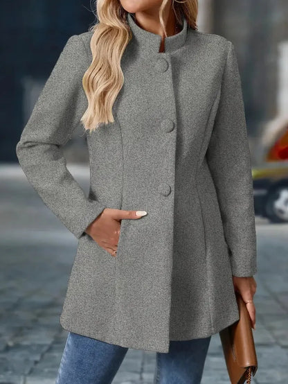 Woman wearing a gray coat with a blurred background