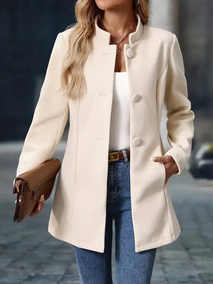 Person wearing a cream coat with a blurred background