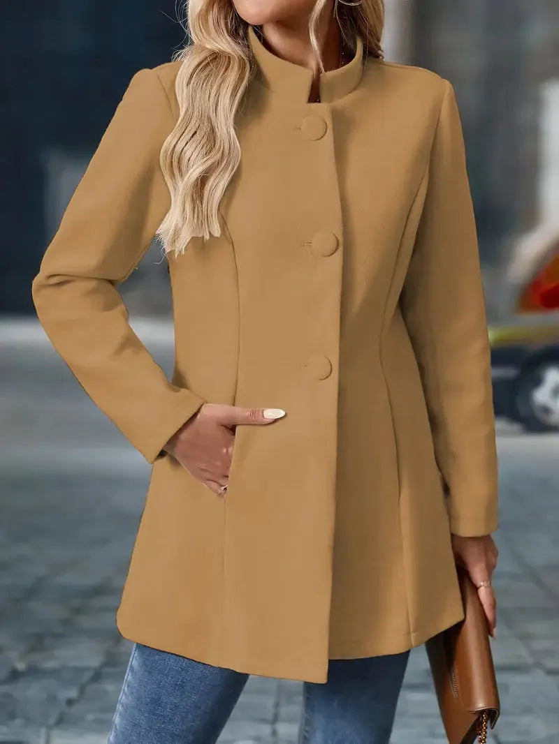 Person wearing a tan coat with a blurred background