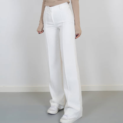 White pants worn by a person on a plain background