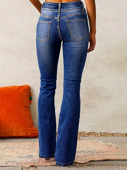 Blue jeans worn by a person on a neutral background